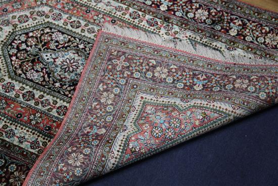 A mathched pair of Qum silk rugs, 5ft 4in by 3ft 4in.